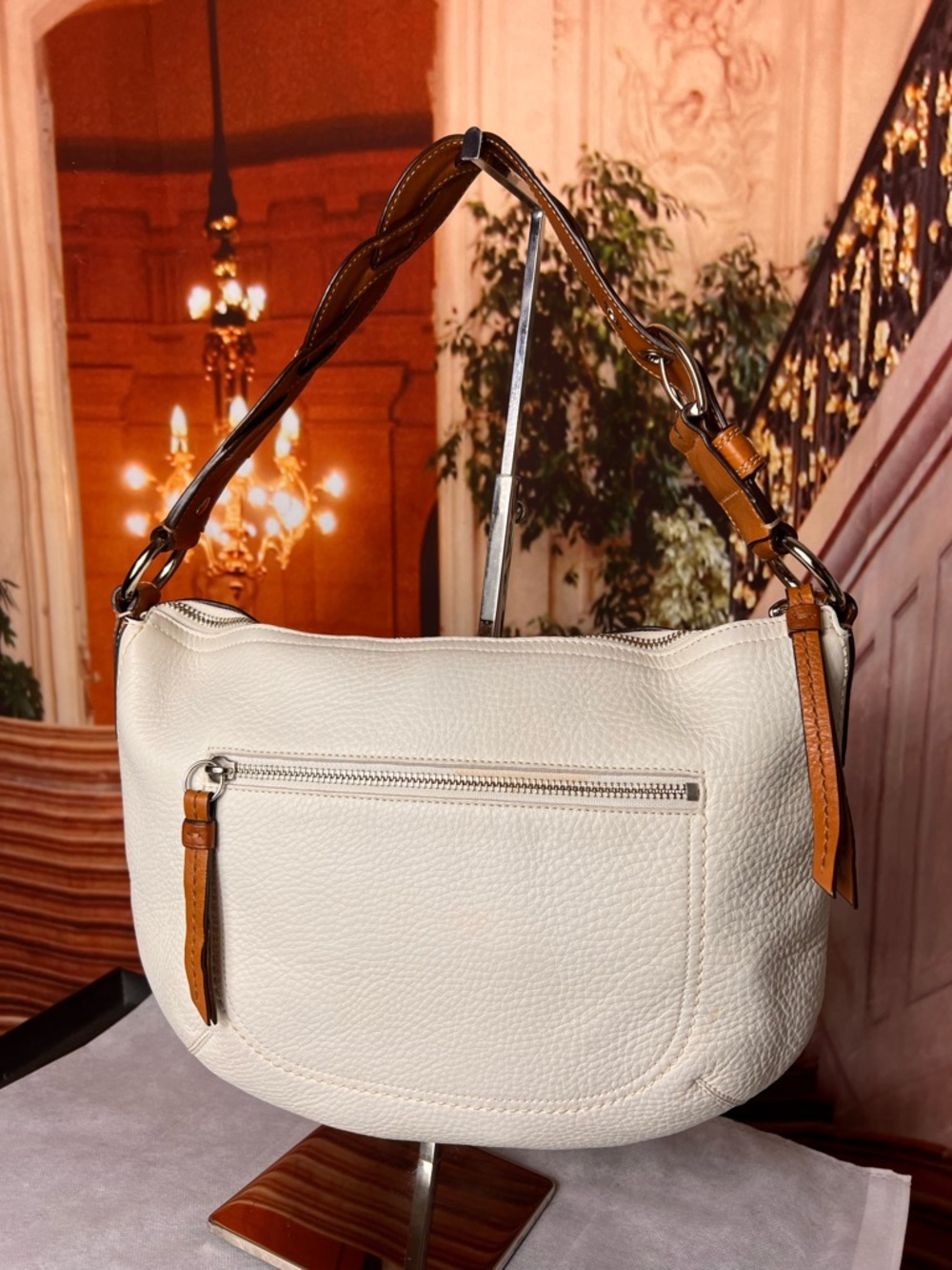 Coach Soho White Pebbled Leather Hobo bag features a distinctive braided handle